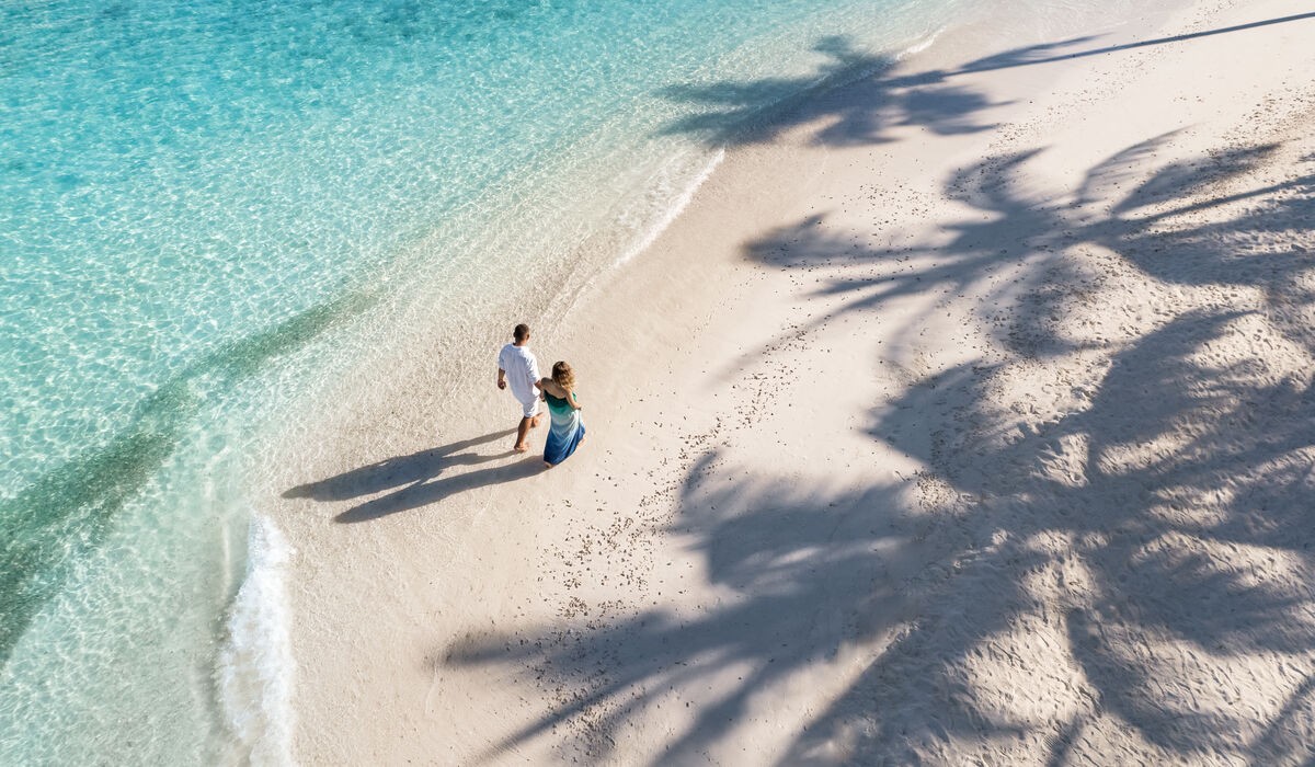 Couple walking on the Kandima Maldives beach