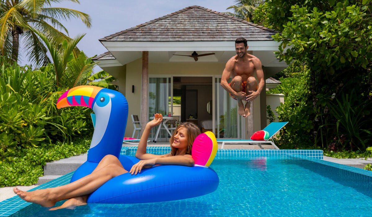 Couple enjoying the pool of their beach villa at Kandima Maldives